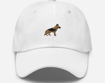 May include: White baseball cap with an embroidered German Shepherd dog in brown and black.