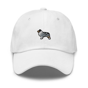 May include: White baseball cap with an embroidered blue merle Australian Shepherd.