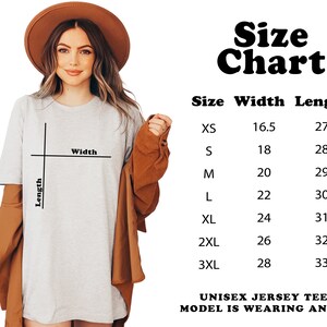 May include: Size chart for a unisex jersey tee. The chart shows the width and length measurements in inches for sizes XS to 3XL. The model is wearing a size XL.