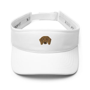 May include: White visor with an embroidered brown dachshund face.