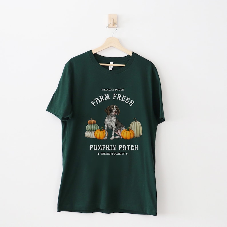 May include: Green t-shirt with a white graphic of a dog sitting in front of pumpkins. The graphic says "Welcome to our Farm Fresh Pumpkin Patch, Premium Quality".