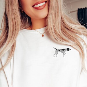 May include: White long-sleeved shirt with a black and white spotted dog illustration on the left chest.