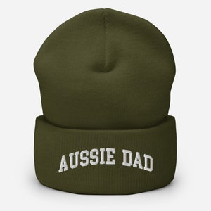 May include: A green beanie with a white embroidered "Aussie Dad" text.
