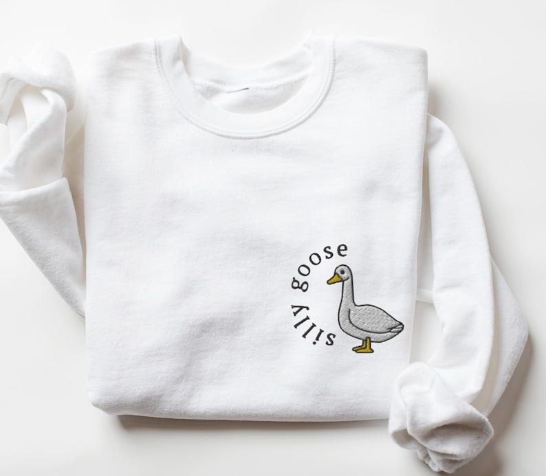 May include: White sweatshirt with a gray goose illustration and the text "Silly goose" in a circle around it.