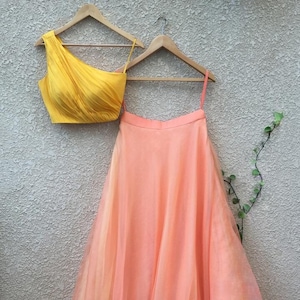 Indian lehenga outfit yellow one off shoulder blouse with peach lehenga