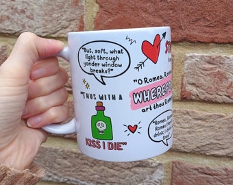 May include: White ceramic mug with a black and green skull and crossbones graphic and the text "Thus with a kiss I die". The mug also features a red heart, a red arrow, and text from Shakespeare's Romeo and Juliet, including "But, soft, what light through yonder window breaks?" and "Wherefore art thou Romeo?"