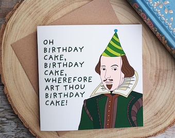 May include: A white card with a green, yellow, and blue party hat on a cartoon illustration of William Shakespeare. The text on the card reads "Oh birthday cake, birthday cake, wherefore art thou birthday cake!"
