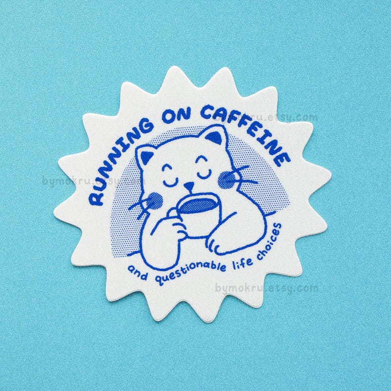 May include: White sticker with a blue starburst design. The sticker features a cartoon cat holding a cup of coffee and the text "Running on caffeine and questionable life choices".
