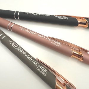 May include: Three pens with rose gold accents and a black, rose gold, and gray finish. Each pen has the words "Give Jehovah the Glory Due His Name" and "Psalm 96:8" engraved on it.