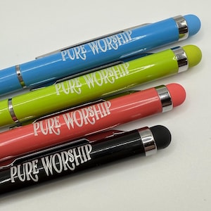 May include: Four pens with black, red, green, and blue bodies. Each pen has a white inscription that reads "PURE WORSHIP".