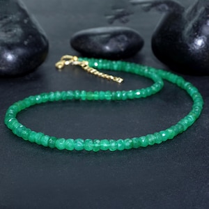 Puede incluir: Un delicado collar de piedras preciosas de esmeralda verde con cierre de oro. El collar está hecho de pequeñas cuentas de esmeralda facetadas.