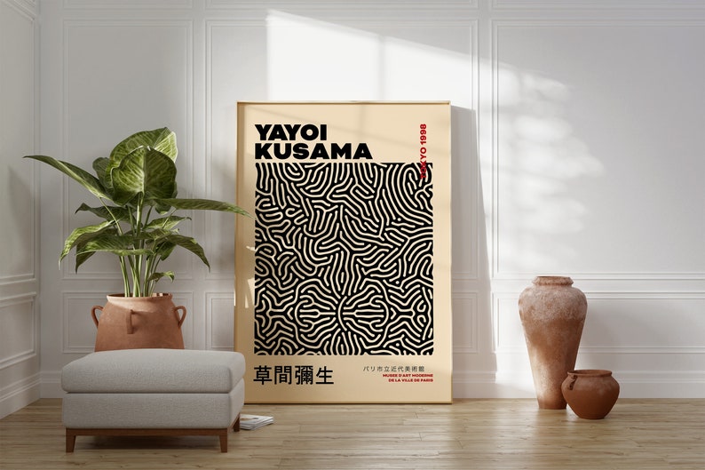 May include: A black and white abstract art print with a geometric pattern. The print is framed in a light wood frame and features the text "Yayoi Kusama" and "Tokyo 1929".