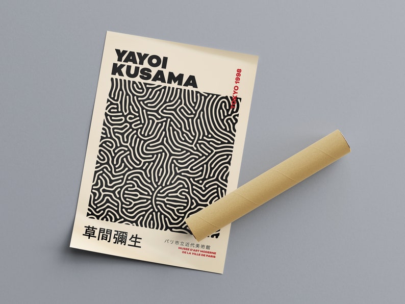 May include: A black and white poster with a geometric pattern and the text "YAYOI KUSAMA" and "草間彌生" in black. The text "TOKYO 1998" is in red in the upper right corner. The poster is rolled up and sitting on a brown cardboard tube.