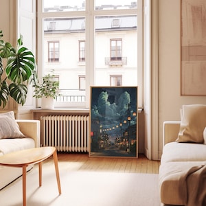 May include: A framed art print depicts a nighttime street scene with glowing lanterns and buildings. The artwork features a palette of blues, greens, and warm orange hues, creating a serene and atmospheric ambiance. The print is displayed in a light-colored wooden frame.