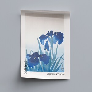 May include: A blue and white print of Japanese irises with the artist's signature "Ohara Koson" at the bottom.