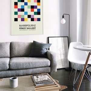 May include: A framed poster with a geometric design in various colors, including black, white, red, yellow, green, and blue. The poster is titled "ELLSWORTH KELLY" and includes the text "FROM TUESDAY, MARCH 15, 1966 FERUS GALLERY LOS ANGELES, CALIFORNIA".