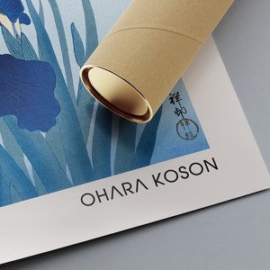 May include: A blue and white print of irises with a Japanese signature and the artist's name "Ohara Koson" printed below. The print is rolled up in a brown tube.