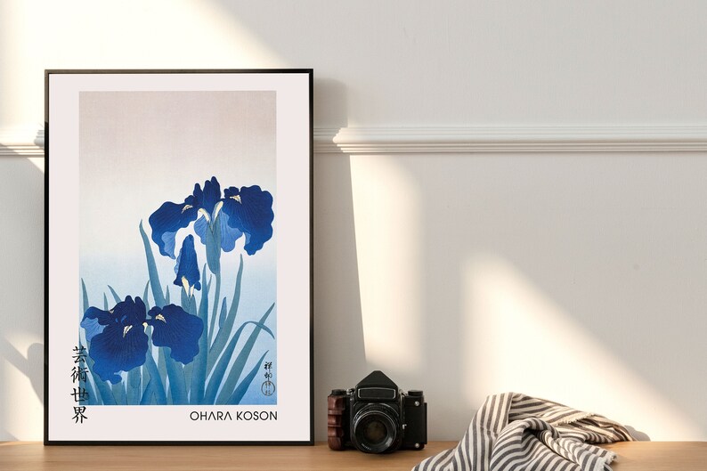 May include: A framed print of a Japanese-style painting of blue irises with green leaves. The print is titled "Ohara Koson" and features Japanese text in the lower left corner.