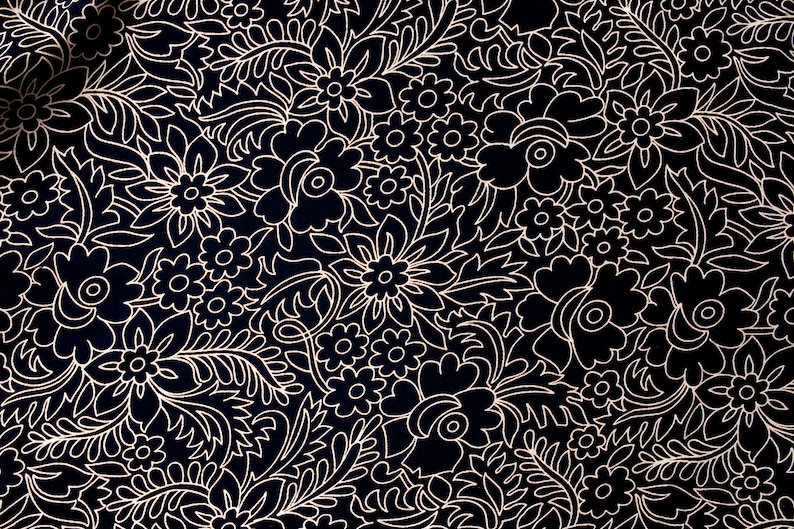 May include: A black fabric with a white floral pattern. The pattern features a variety of flowers and leaves, all outlined in white.