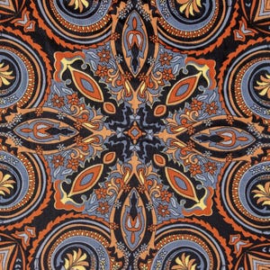 May include: A black background with a paisley pattern in shades of orange, blue, and yellow. The pattern is symmetrical and creates a mandala-like design.