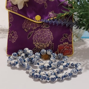 Chinese blue porcelain hand painted vintage necklace. Unique and handcrafted.  Hand knotted. Elegant, Stylish  and in beautiful condition.