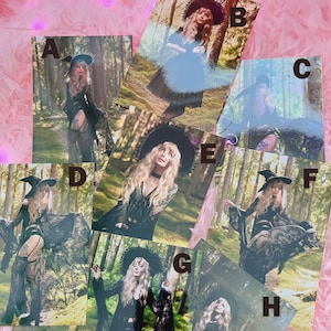May include: A set of eight 4x6 inch photographs featuring a woman dressed in a black lace dress and a wide-brimmed hat. The photos are set against a backdrop of a forest.