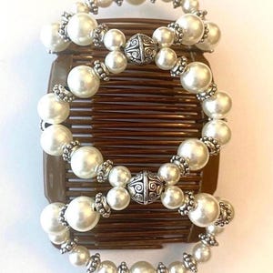 May include: Ornate hair comb featuring faux pearls and silver-toned accents. The comb is brown and has multiple rows of teeth. The text "Ornate Pearl with Brown Combs" is at the bottom of the image.