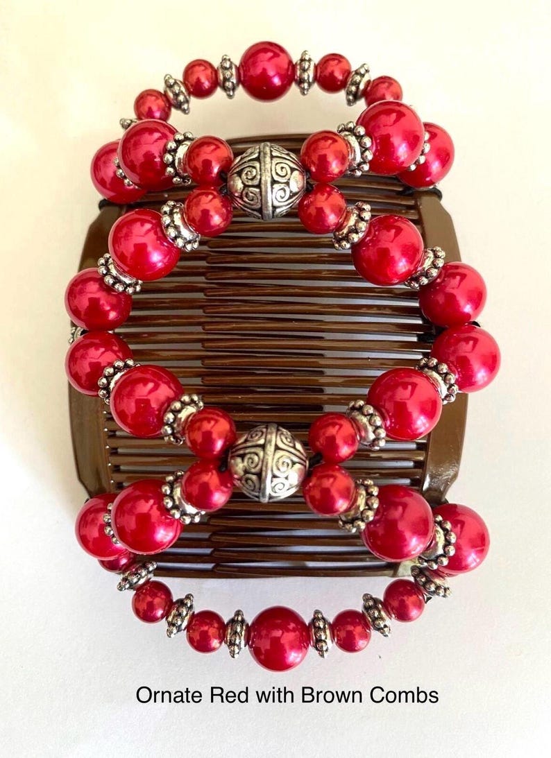 May include: Ornate red hair combs with brown bases. The combs are adorned with red beads and silver-colored accents. The text "Ornate Red with Brown Combs" is visible at the bottom of the image.