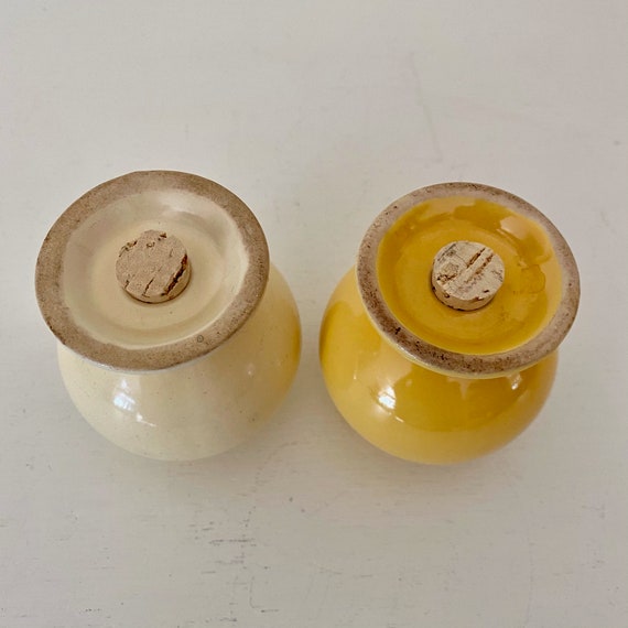 Yellow salt outlet and pepper shakers