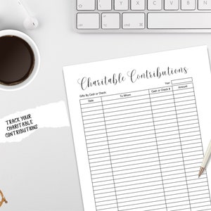 May include: A printable charitable contributions tracker with columns for date, year, to whom, cash or check number, and amount. The text "Track Your Charitable Contributions" is written on a piece of paper in the lower left corner of the image.