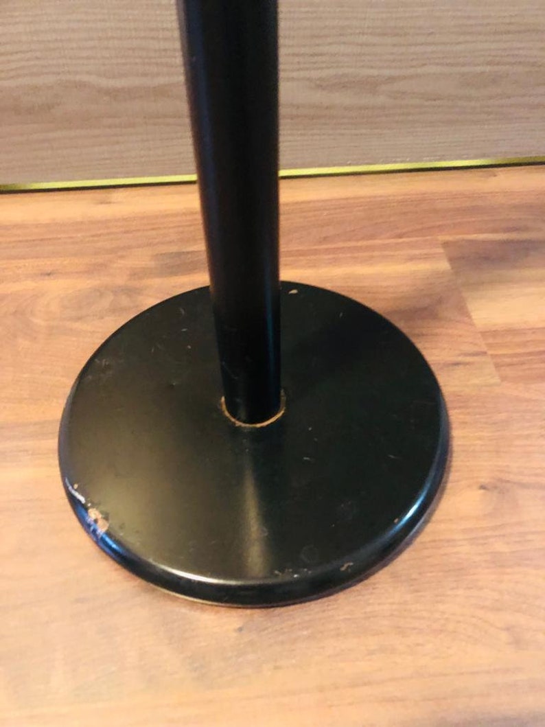 Peut inclure: Un porte-manteau en m&eacute;tal noir avec une base ronde. La base pr&eacute;sente une l&eacute;g&egrave;re &eacute;br&eacute;chure sur le bord.