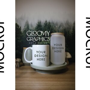 May include: White ceramic mug and a frosted glass tumbler with a bamboo lid and straw. Both mugs have the text "Your design here" printed on them. The background is a blurred image of a forest.