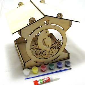 May include: Wooden birdhouse kit with a bird design, includes paint, a brush, and glue.