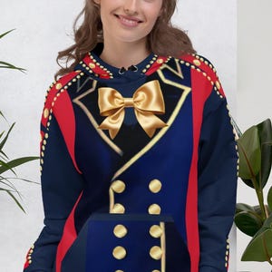 May include: Navy blue hoodie with a gold bow and button design. The hoodie features red accents on the sleeves and gold detailing. The design resembles a military uniform, with a front pocket and a drawstring hood.
