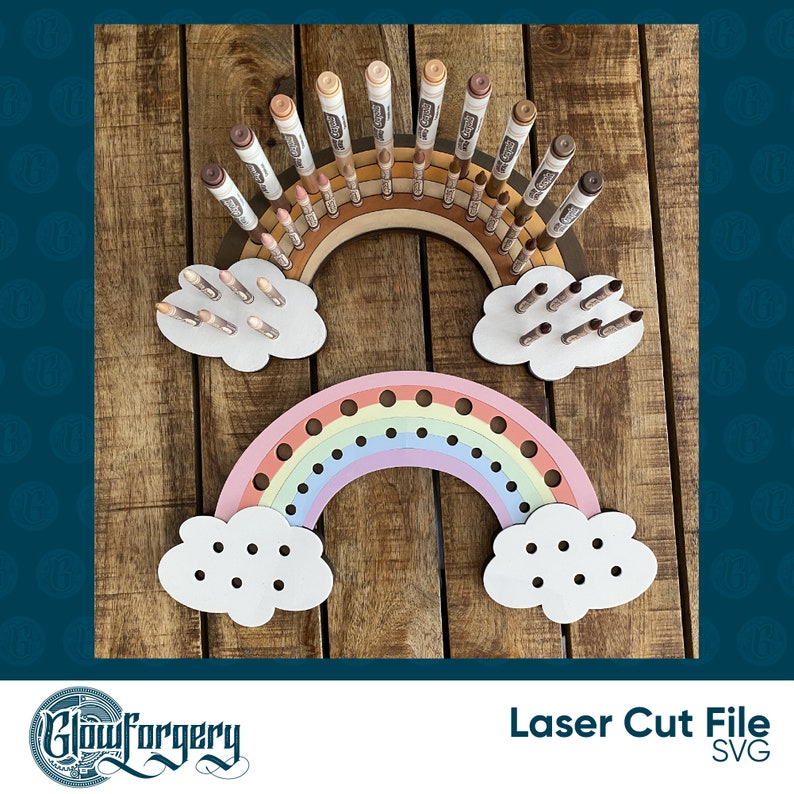 May include: Laser cut file for a rainbow-shaped marker holder with clouds. The rainbow has 18 holes for markers and the clouds have 10 holes each. The rainbow is painted in pastel colours and the clouds are white.