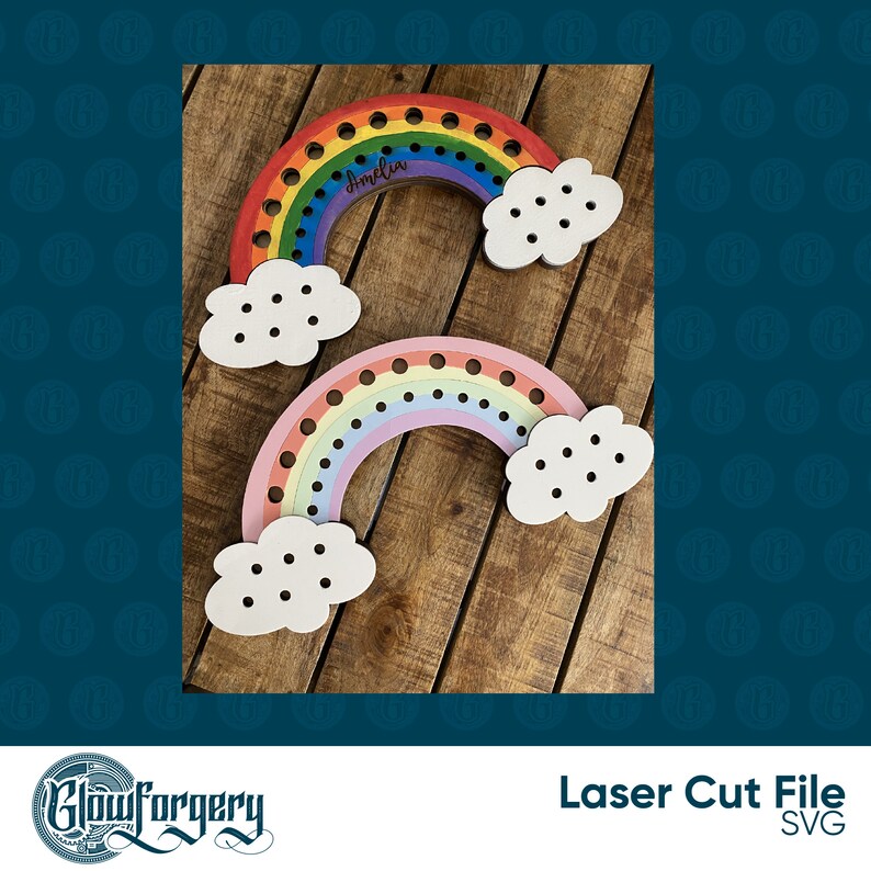 May include: Two rainbow-coloured wooden rainbow shapes with clouds. The larger rainbow is painted in red, orange, yellow, green, blue, indigo, and violet. The smaller rainbow is painted in pink, light blue, lavender, and yellow. Both rainbows have holes for threading string or yarn. The larger rainbow has the name "Amelia" written on it.