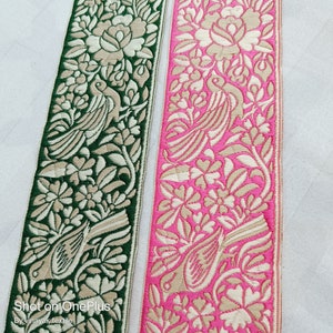 May include: Two fabric trims with a floral and bird design. One trim is green with a beige floral pattern and the other is pink with a beige floral pattern.