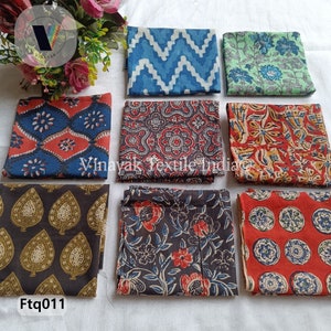 May include: Nine fabric squares with different patterns. The patterns include geometric shapes, floral designs, and paisley prints. The colors are red, blue, green, brown, and white. The fabric squares are arranged in a grid pattern. The text "Ftg011" is in the lower left corner of the image.