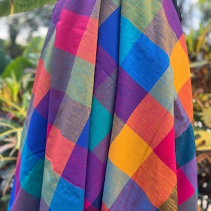 May include: A vibrant, multicolored plaid fabric with a repeating square pattern. The fabric features a spectrum of colors, including pink, orange, yellow, blue, and purple. The text "Ctnf048" is visible at the bottom.