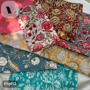 May include: An assortment of patterned fabrics in shades of pink, white, red, yellow, blue, and teal. The fabrics display floral and paisley patterns. The text "Ftg012" is visible in the bottom left corner.