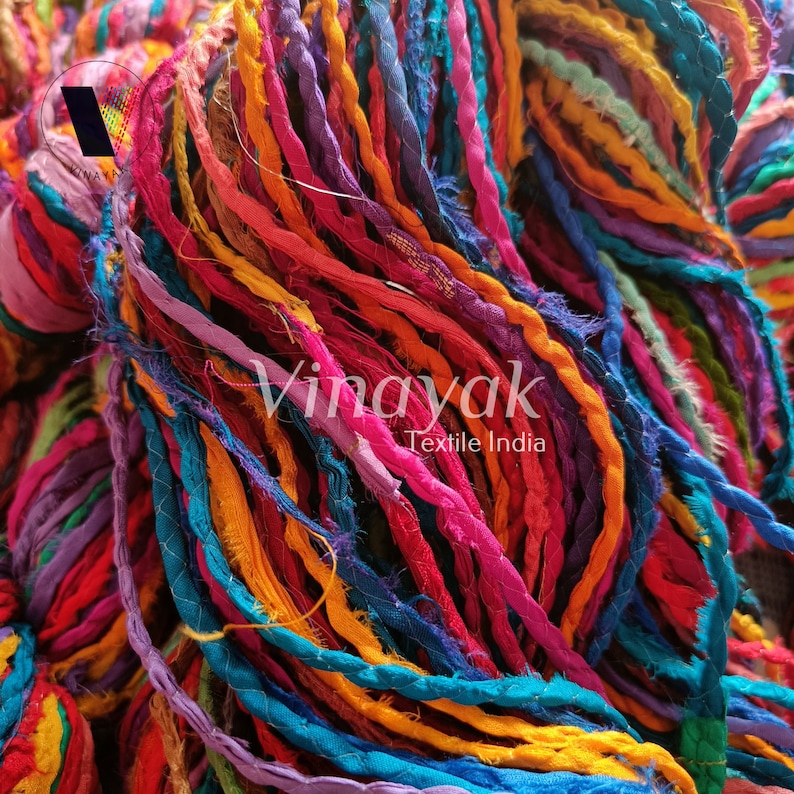 May include: A close-up of a bundle of colourful, twisted silk ribbon. The ribbon is made from recycled saris and is perfect for crafting and decorating.