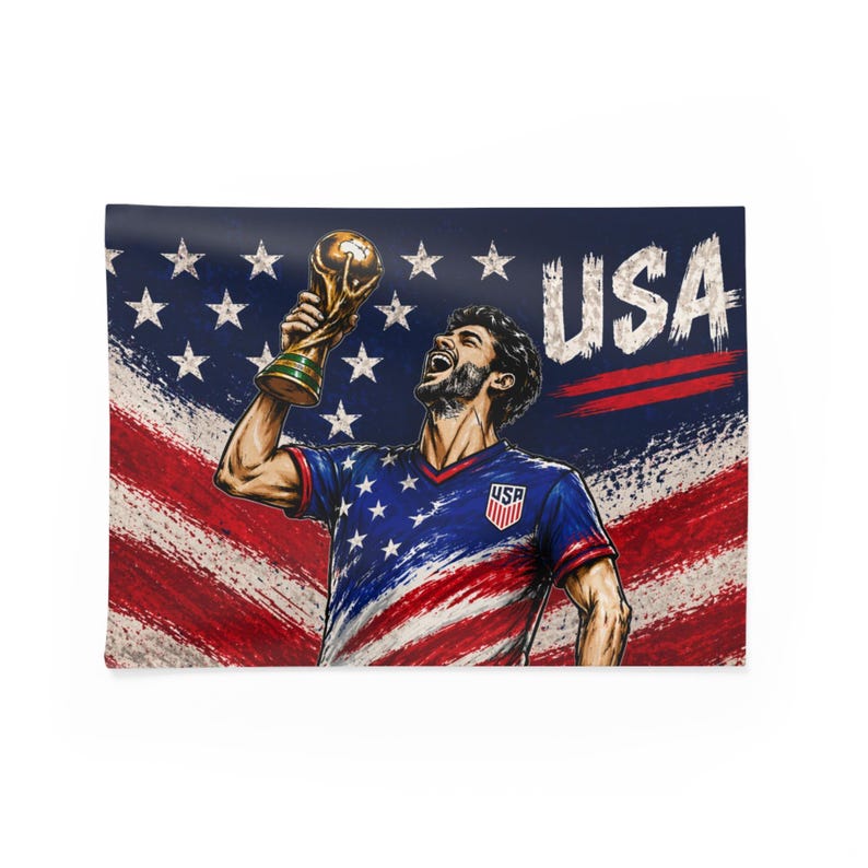 May include: A rectangular wall tapestry featuring a stylized illustration of a soccer player holding a trophy. The player is wearing a blue jersey with the USA emblem. The background showcases the American flag and the word "USA".