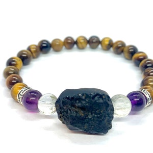 May include: A beaded bracelet with tiger's eye, amethyst, clear quartz, and a large black obsidian stone.