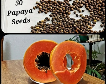 May include: 50 papaya seeds. Two halves of a papaya fruit are on a white plate, sitting on a wooden table. The papaya fruit is orange and has black seeds inside.