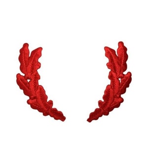 May include: A pair of red embroidered laurel wreaths, each with five leaves, arranged in a symmetrical design.