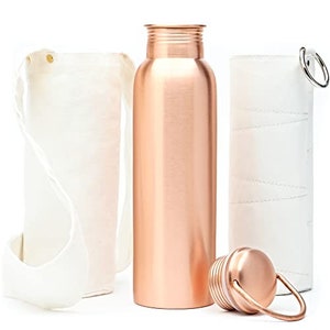 May include: A copper-colored water bottle with a matching lid and a white canvas carrying bag. The bottle is cylindrical and has a textured lid. A second white canvas bag is also included.
