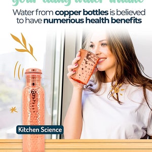 May include: A hammered copper water bottle with a screw-on lid. The bottle is sitting on a wooden surface. The text "Kitchen Science" is printed on the bottle.