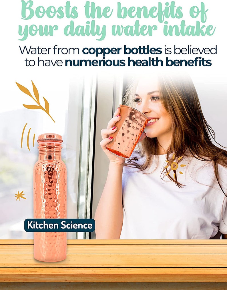 May include: A hammered copper water bottle with a screw-on lid. The bottle is sitting on a wooden surface. The text "Kitchen Science" is printed on the bottle.