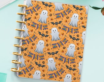 May include: A Halloween-themed planner cover with a repeating pattern of ghosts, bats, candy corn, and "BOO" banners on an orange background.