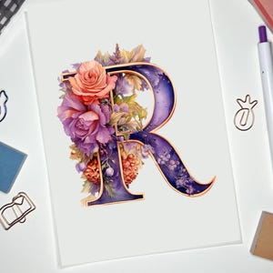 May include: A floral watercolor print featuring the letter "R" in a deep purple hue with a gold outline. The letter is adorned with a bouquet of pink and purple roses, and other flowers and foliage. The print is on a white background.